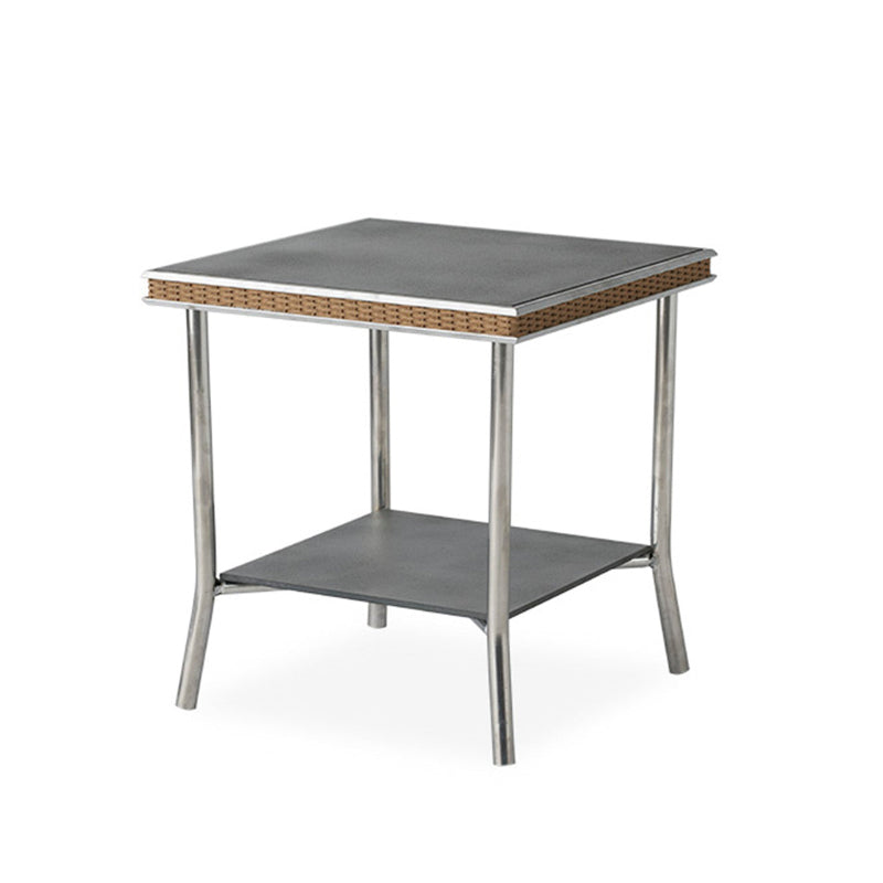 Small square table with metal frame and woven top on a white background