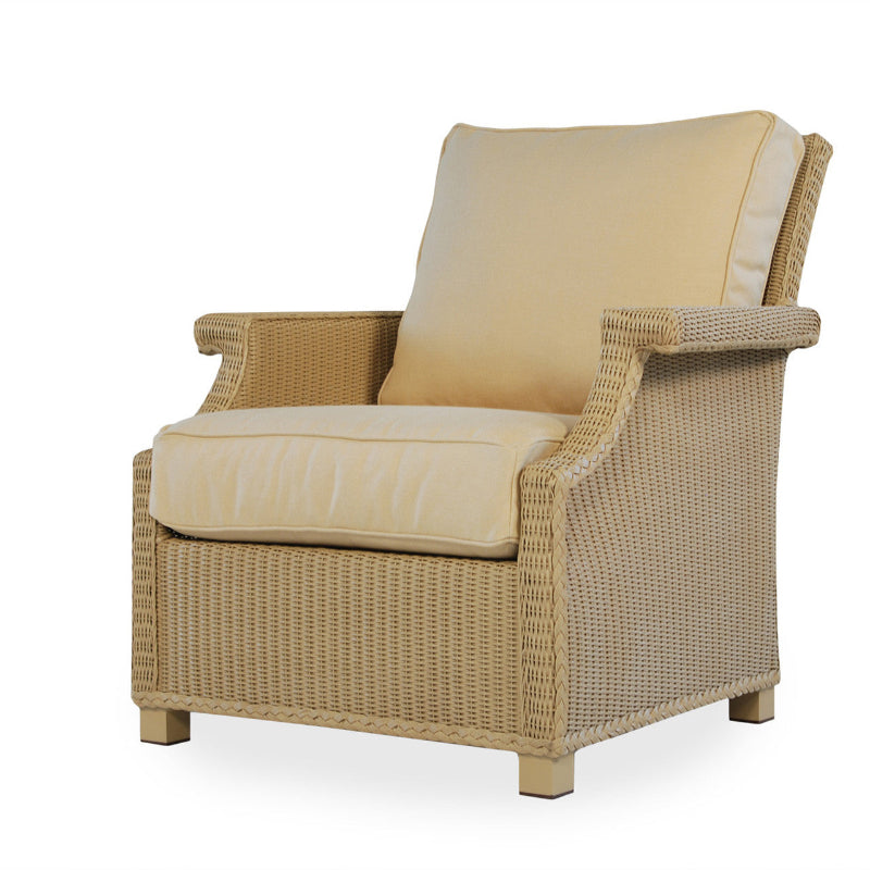 Beige wicker armchair with cushions on a white background
