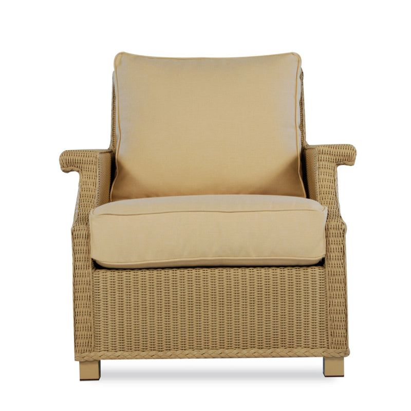 Beige wicker chair with cushion on a white background
