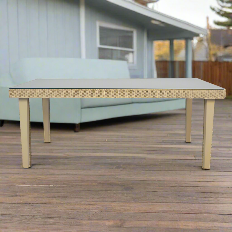 Outdoor table with wicker-style legs on a wooden deck