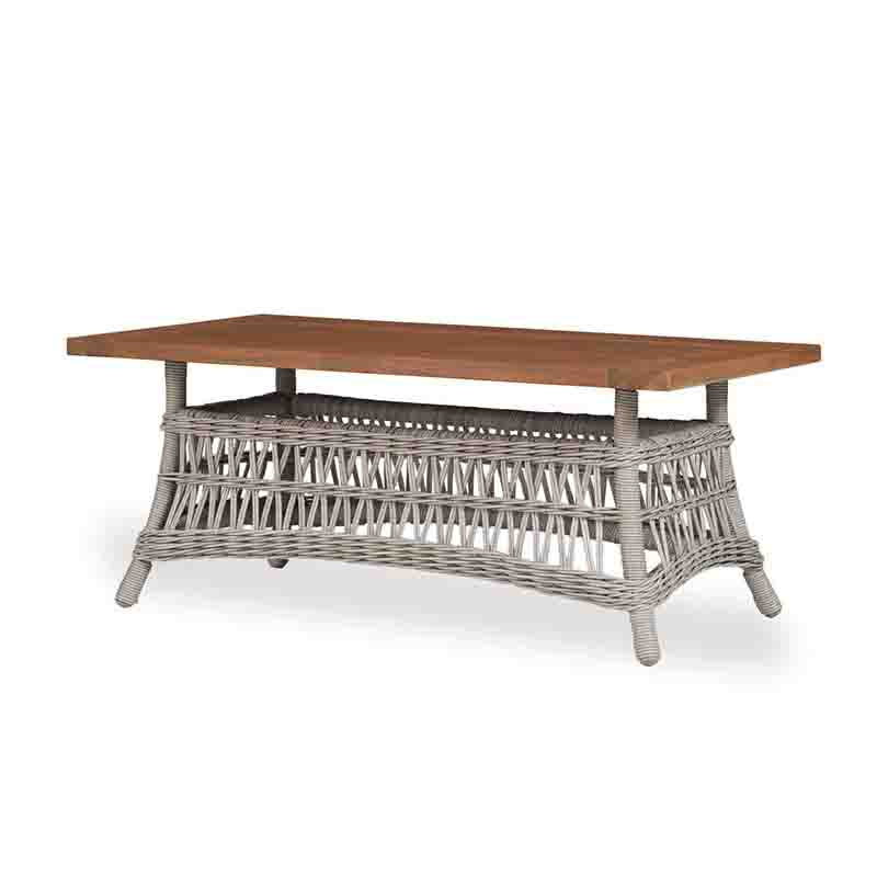 Wooden table with wicker base on a white background