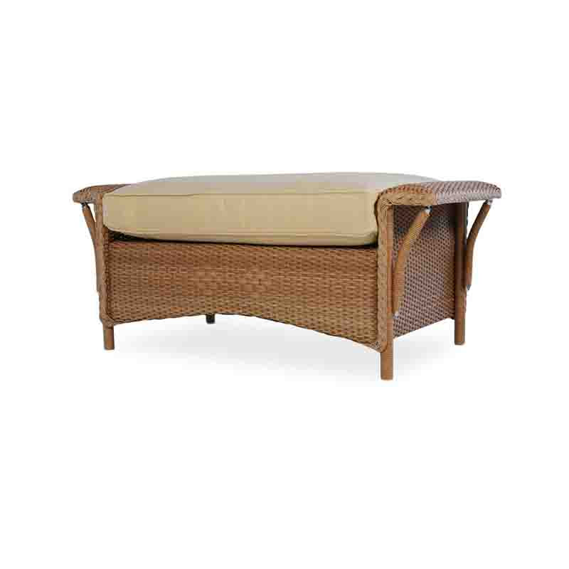 Wicker outdoor bench with beige cushion on a white background