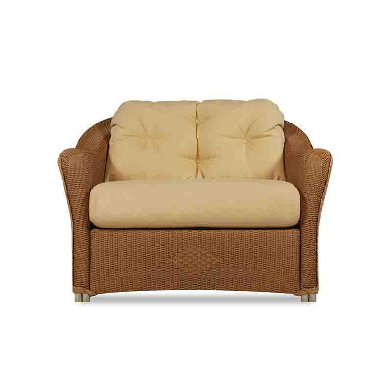 Wicker loveseat with beige cushions on a white background