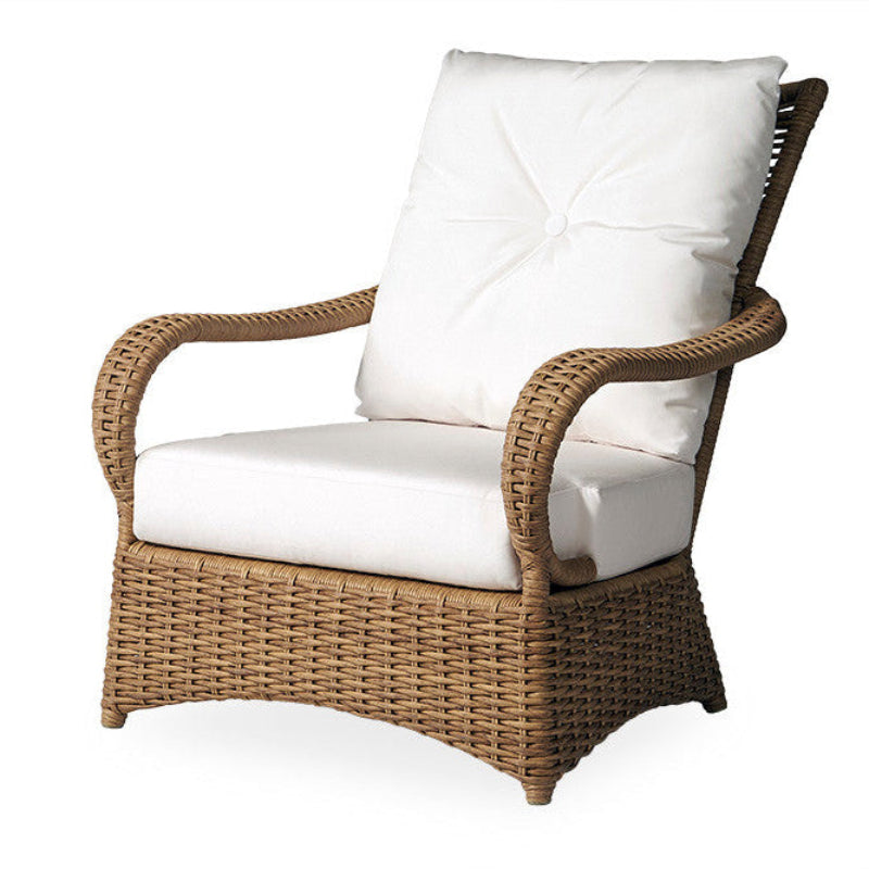 Wicker chair with white cushions on a white background