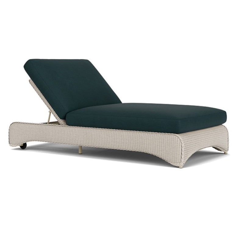 Beige outdoor lounge chair with dark blue cushions on a white background