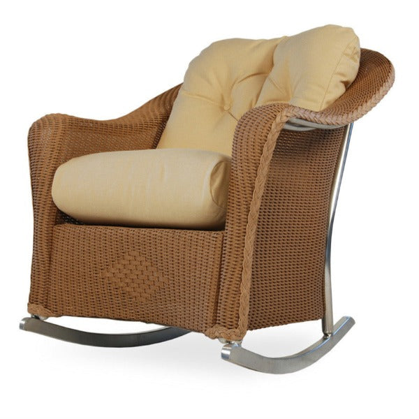 A beige wicker lounge rocker with a subtle loom texture, featuring a built-in cushion for seating and a welded aluminum frame.