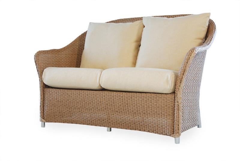 A beige wicker love seat with a sleek design and cushions, featuring a durable aluminum frame.