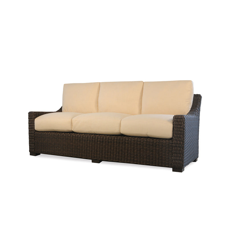 Wicker outdoor sofa with beige cushions on a white background