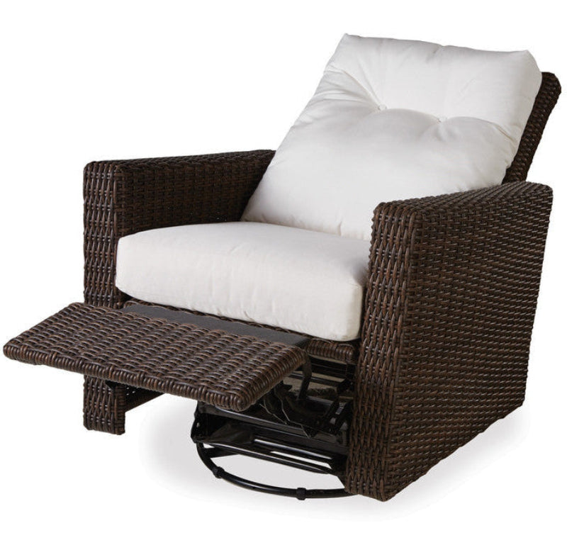 Brown wicker recliner chair with white cushions on a white background