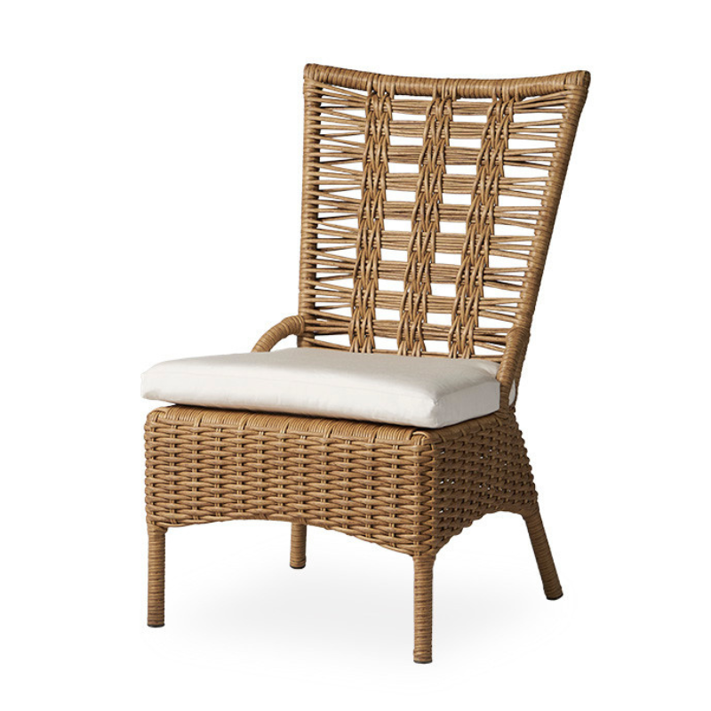Wicker chair with a white cushion on a white background