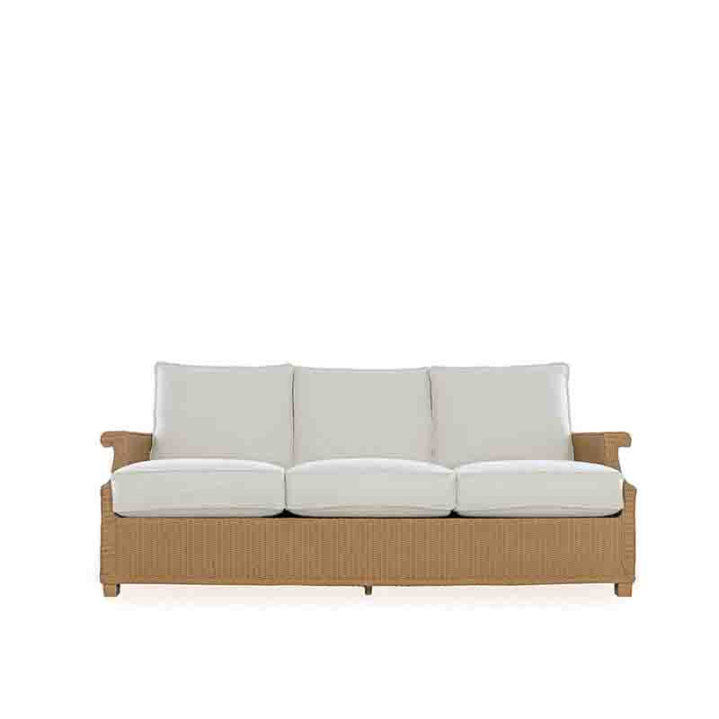 Sofa with wicker frame and white cushions on a white background