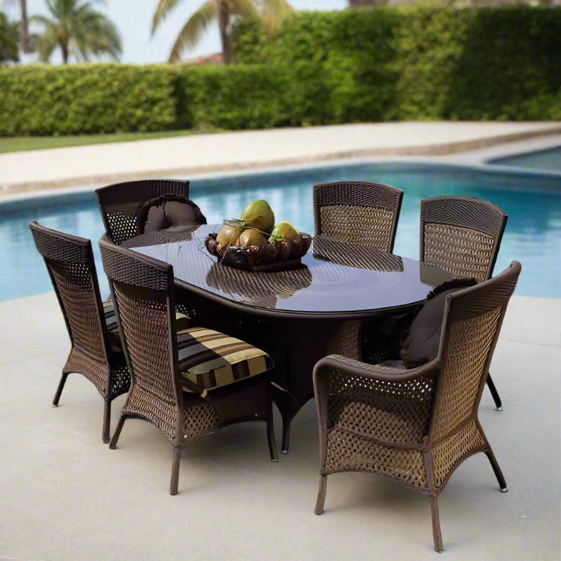 Outdoor dining set with a round table and chairs by a pool