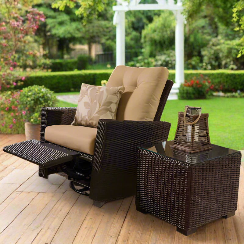 Wicker recliner chair with cushions on a wooden deck in a garden setting