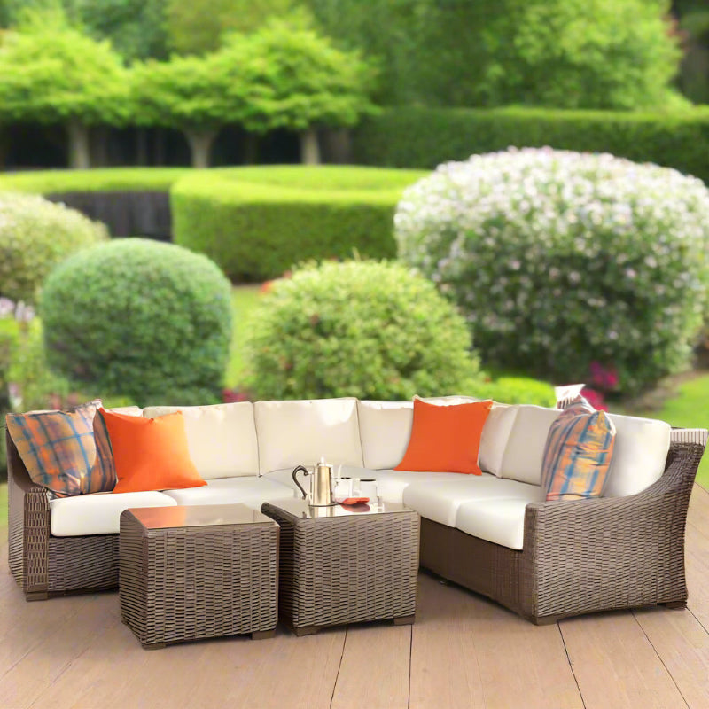 Outdoor patio furniture set with cushions in a garden setting