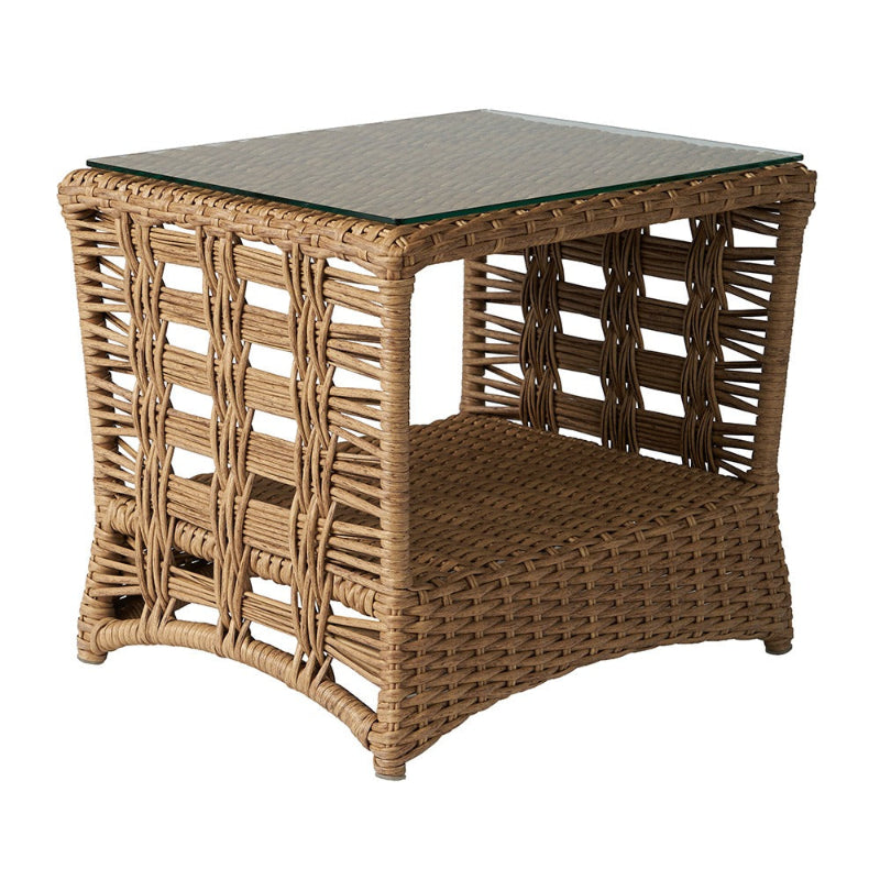 Wicker side table with glass top on a white background