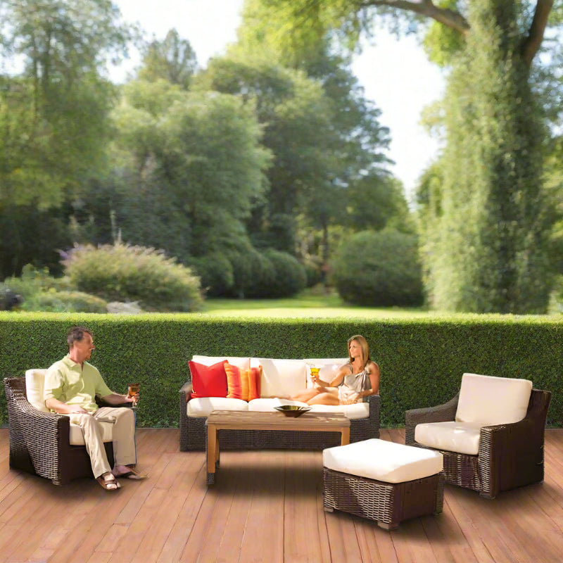 Two people sitting on outdoor furniture set in a garden
