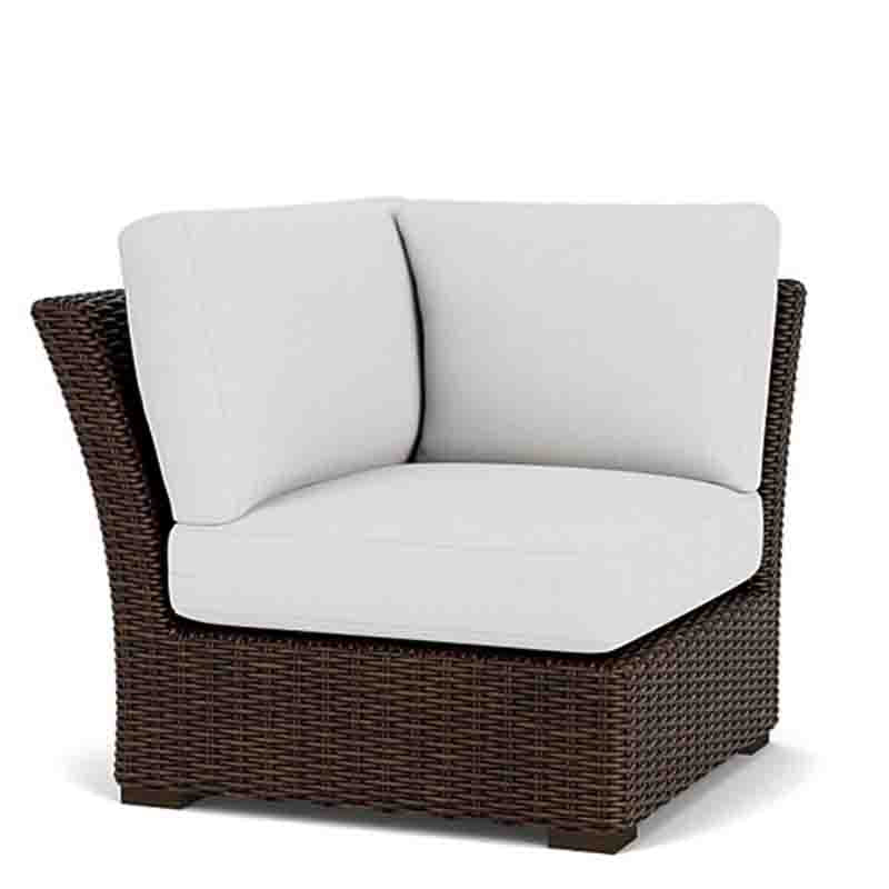 Wicker chair with white cushions on a white background