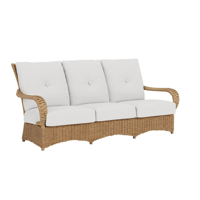 Wicker outdoor sofa with white cushions on a white background