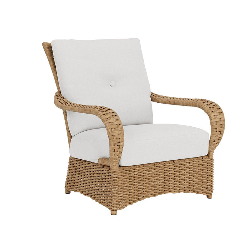 Wicker chair with white cushions on a white background