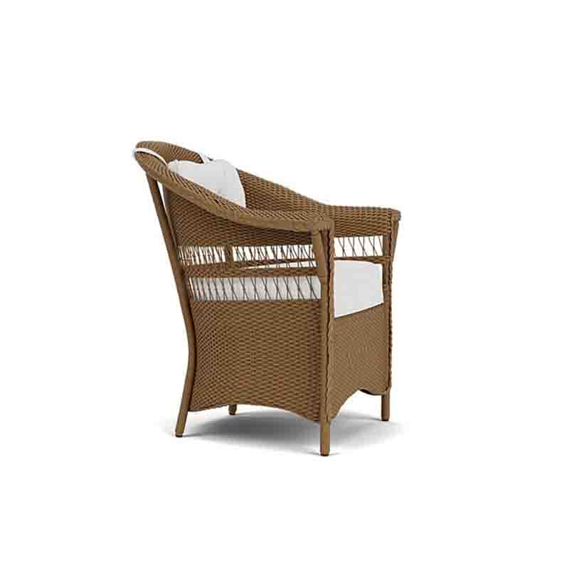 Wicker chair with white cushion on a white background