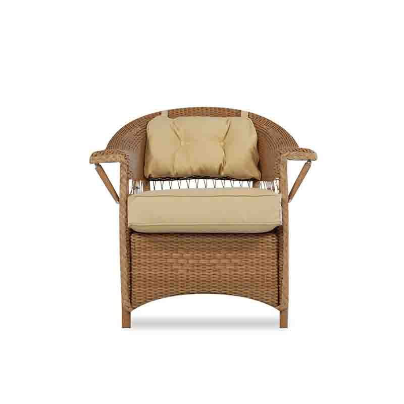 Wicker chair with beige cushions on a white background
