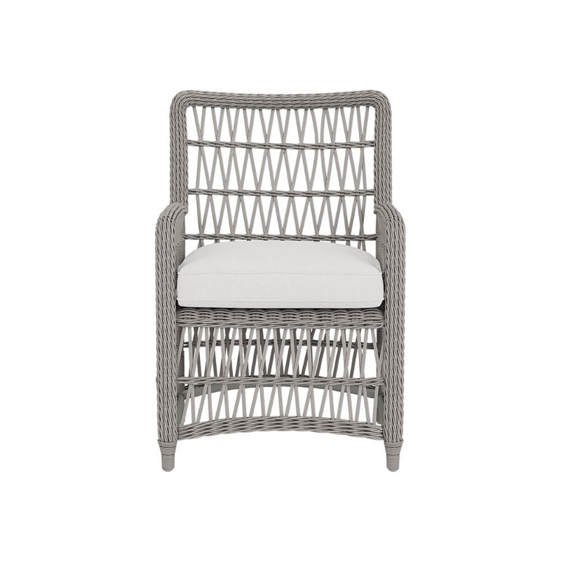 Wicker armchair with a white cushion on a white background