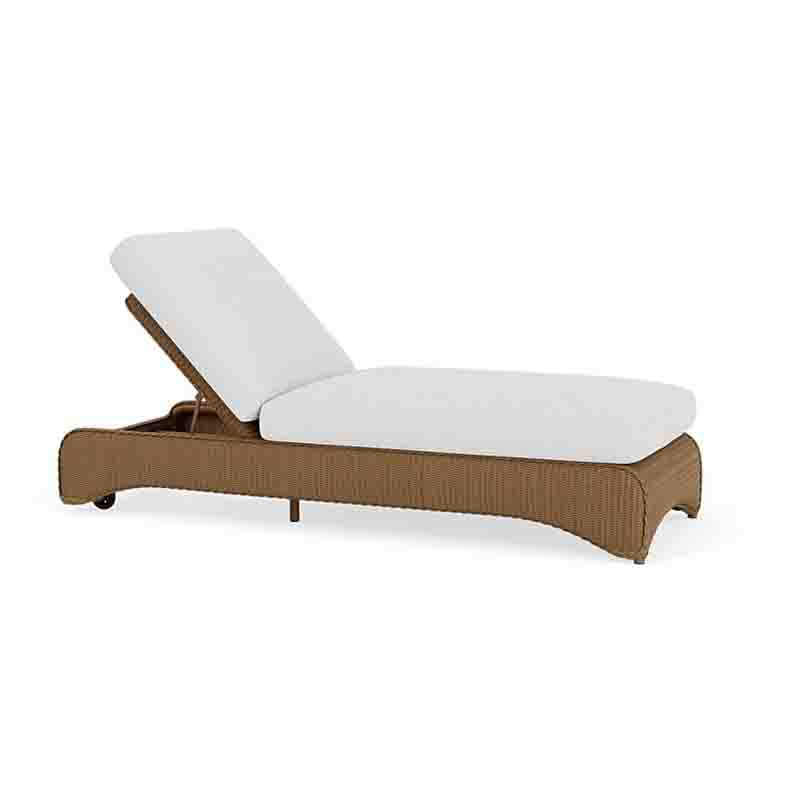 Brown wicker sun lounger with white cushion on a white background