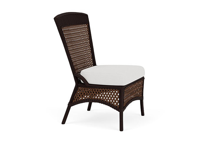 Wicker chair with a white cushion on a white background