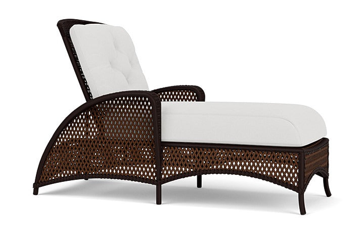 Wicker outdoor lounge chair with white cushion on a white background