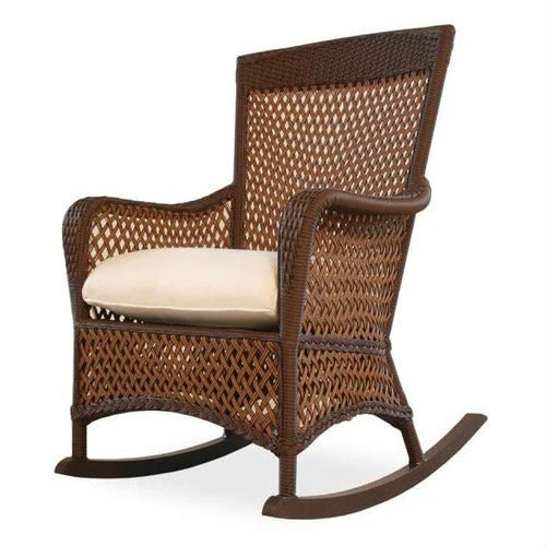 Wicker rocking chair with a cream cushion on a white background