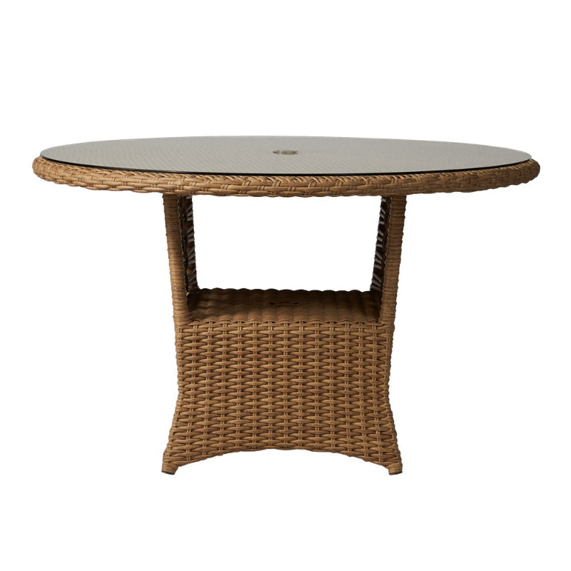 Round wicker table with glass top on a white background