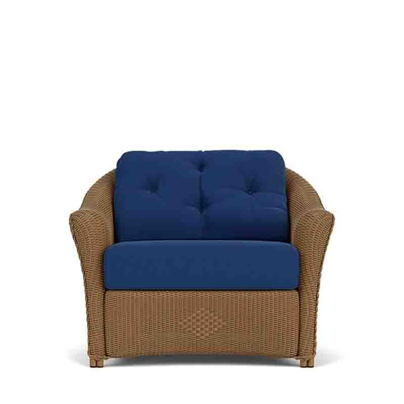 Chair with wicker frame and navy cushions on a white background