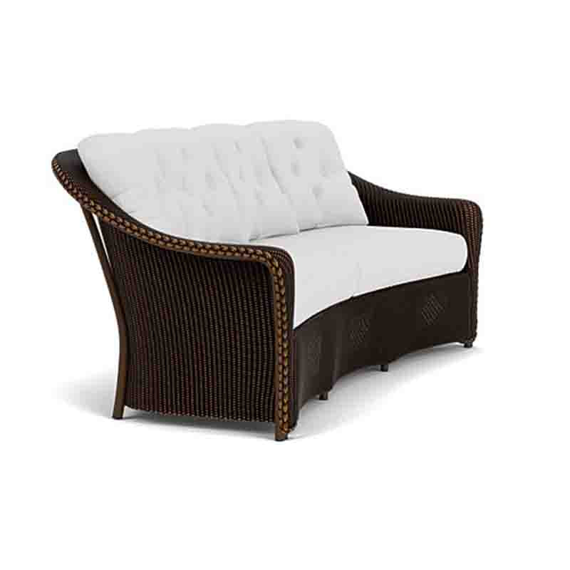 Brown wicker outdoor chair with white cushion on a white background
