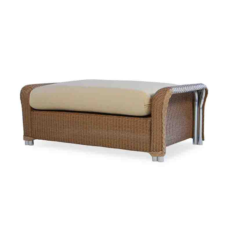 Wicker ottoman with beige cushion on a white background