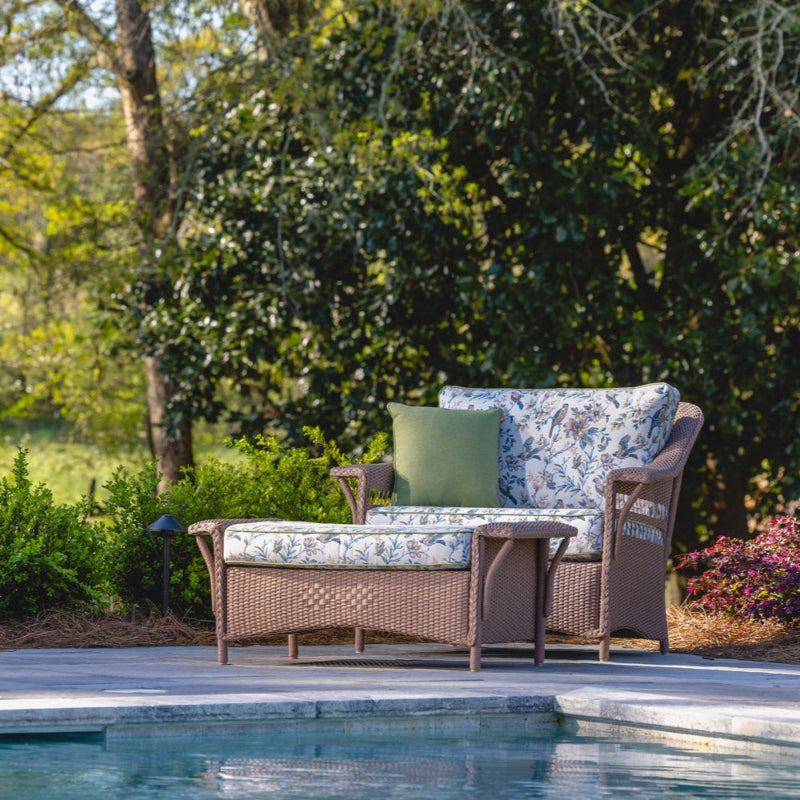 Outdoor patio set with cushions by a poolside
