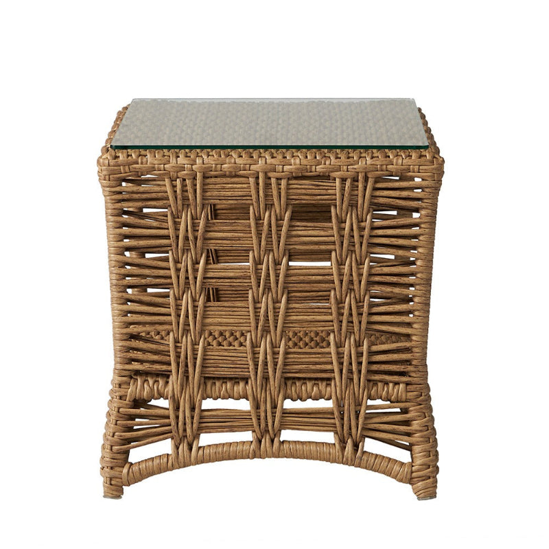 Wicker side table with glass top on a white background