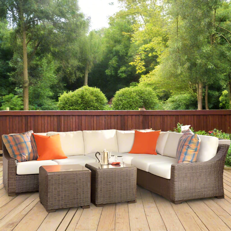 Outdoor patio furniture set with cushions on a wooden deck