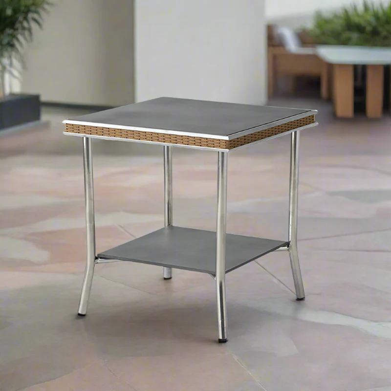 Small square table with a gray top and metal legs on a tiled floor.