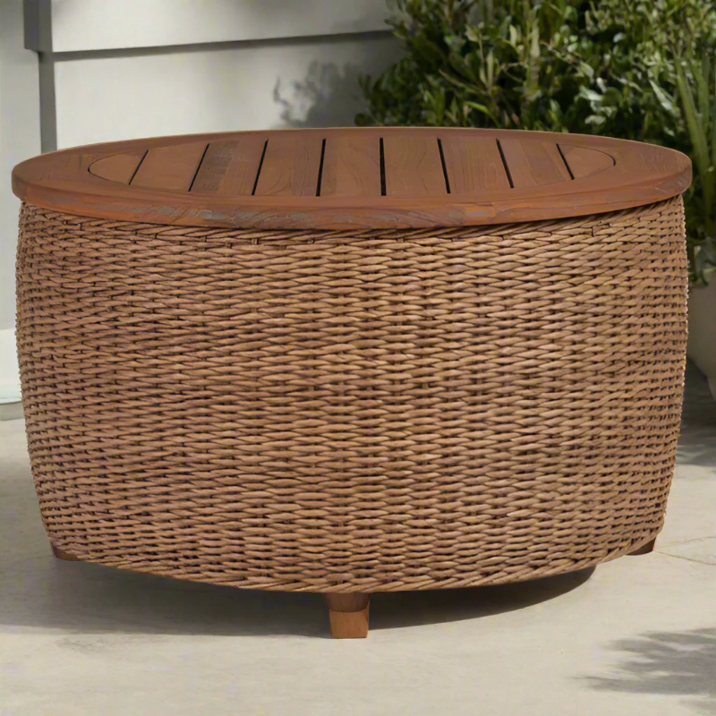 Round wicker storage ottoman with wooden top on a patio