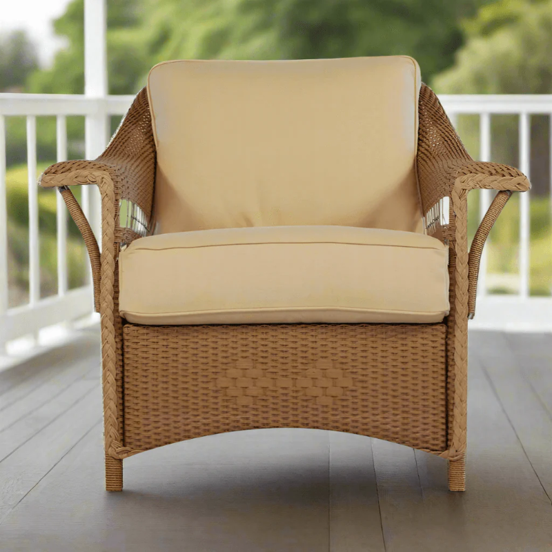Wicker chair with beige cushions on a patio