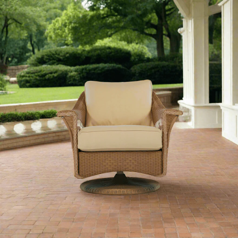 Wicker chair with beige cushions on a patio