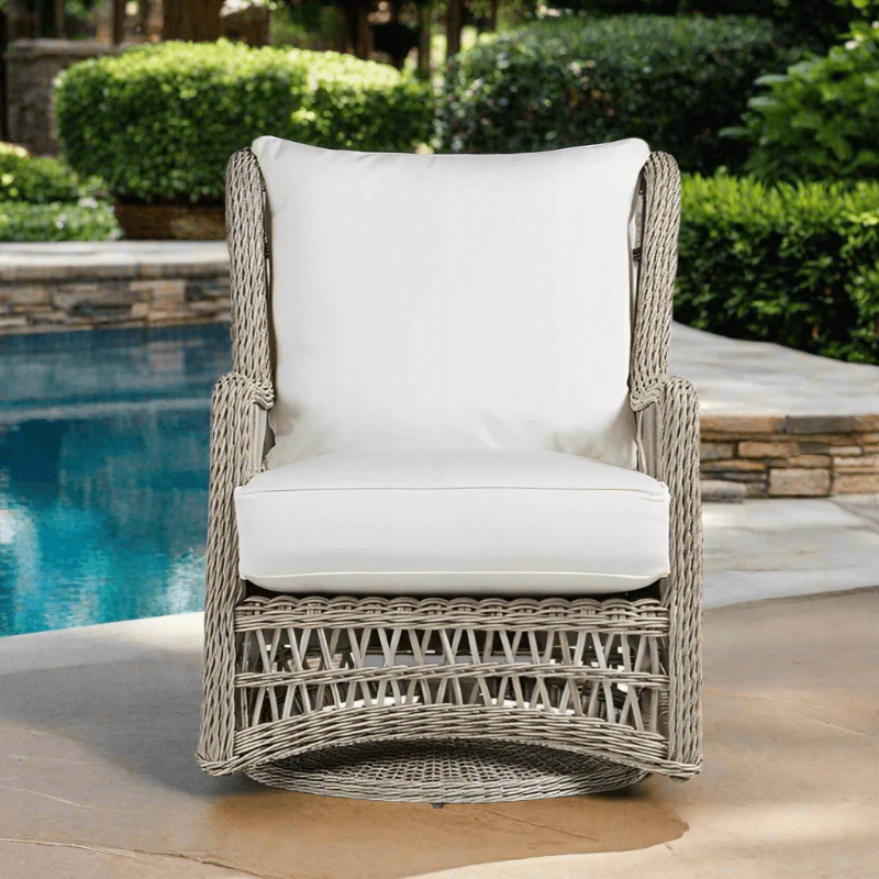 Wicker chair with white cushion by a poolside
