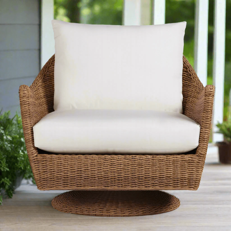Wicker chair with white cushion on a wooden deck