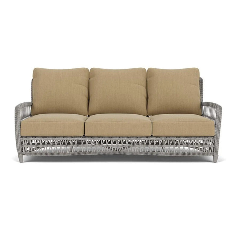 Beige cushioned sofa with a metal frame on a white background