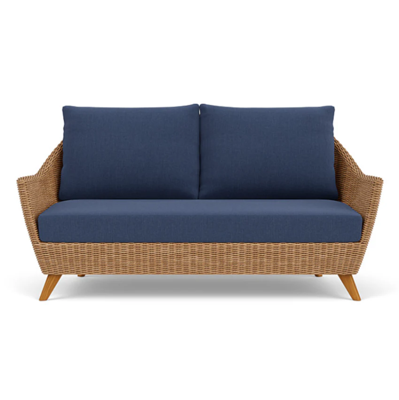 Wicker outdoor sofa with blue cushions on a white background
