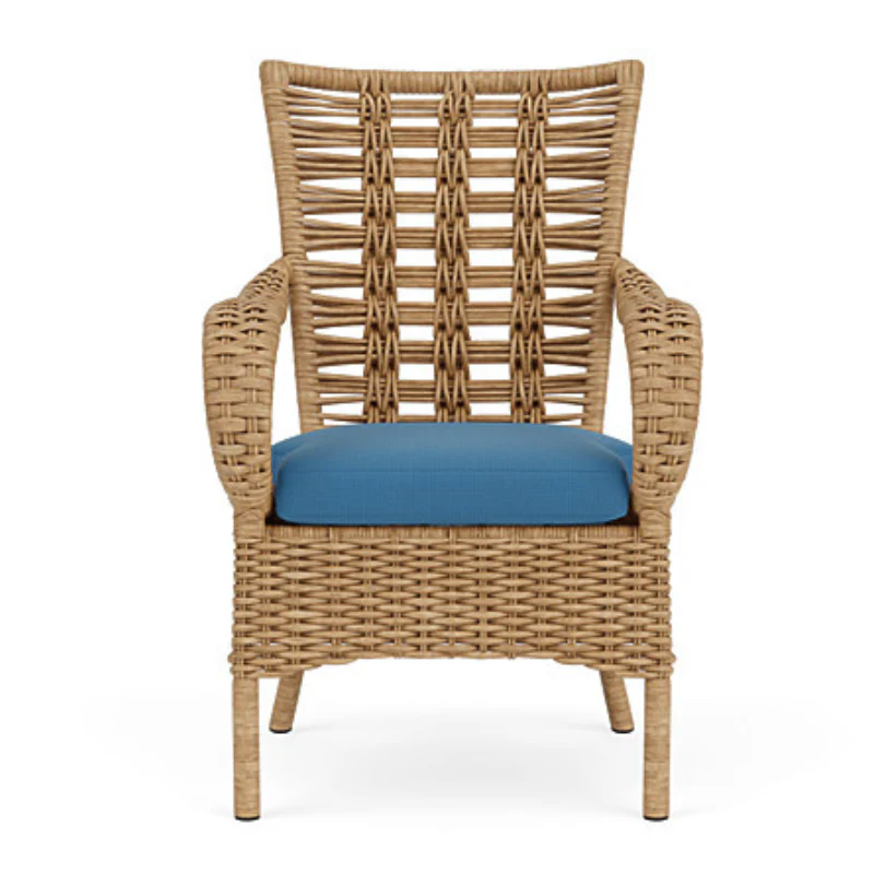 Wicker armchair with a blue cushion on a white background