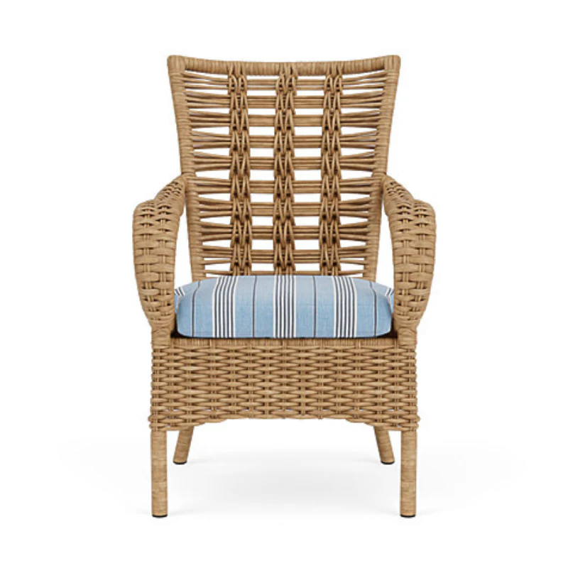 Wicker armchair with a blue cushion on a white background