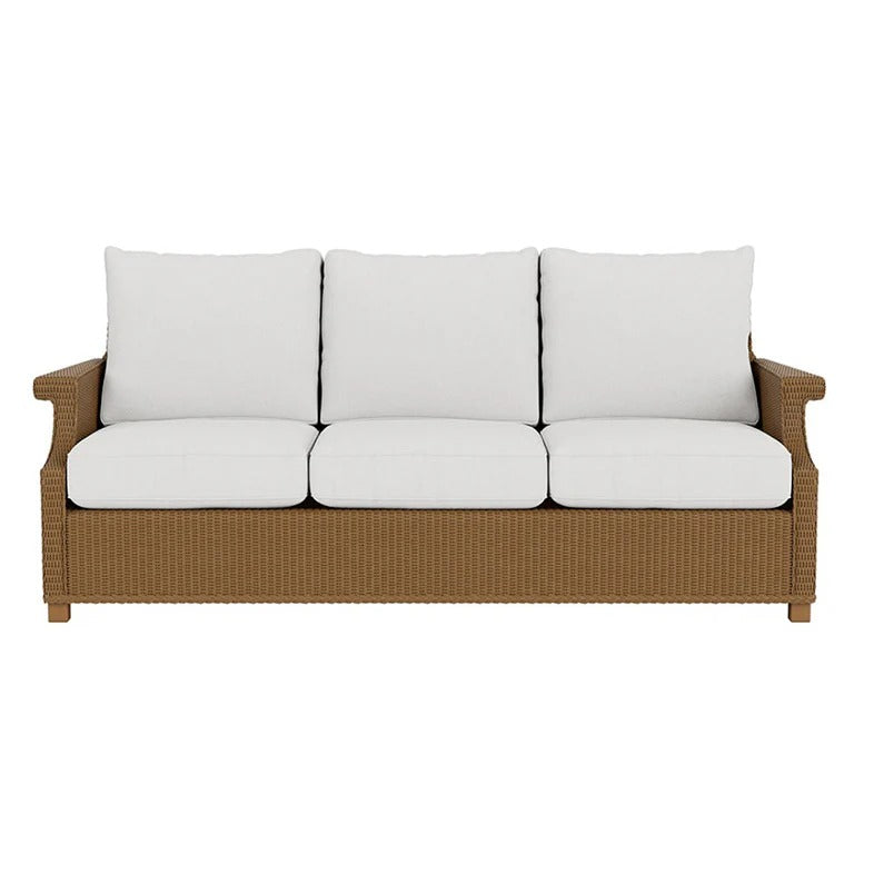 Brown wicker sofa with white cushions on a white background