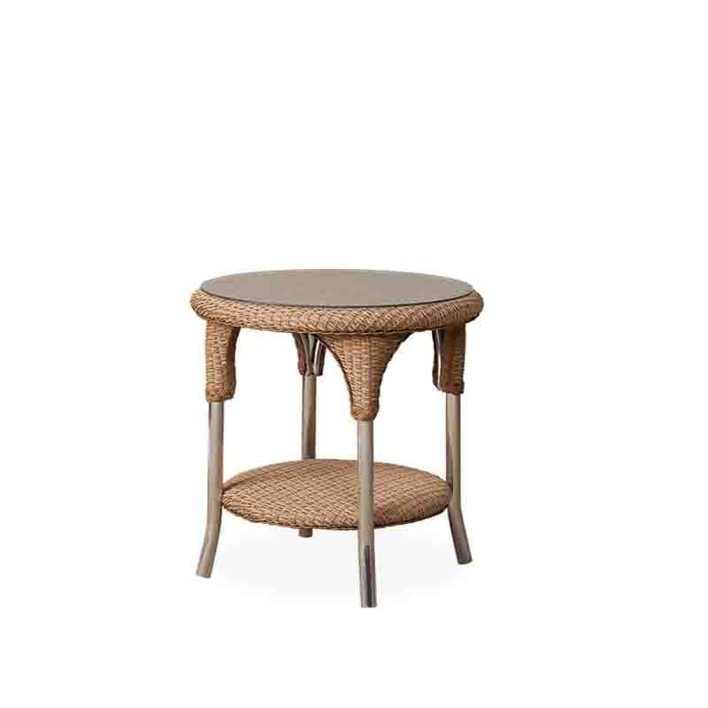 Round wicker side table with a beige top on a white background