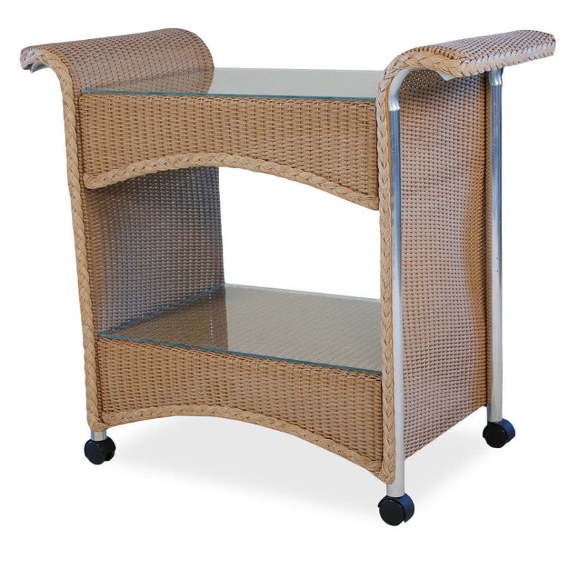 A wicker bar cart with a glass shelf on top and caster wheels for mobility. Features a natural brown color and a curved design.